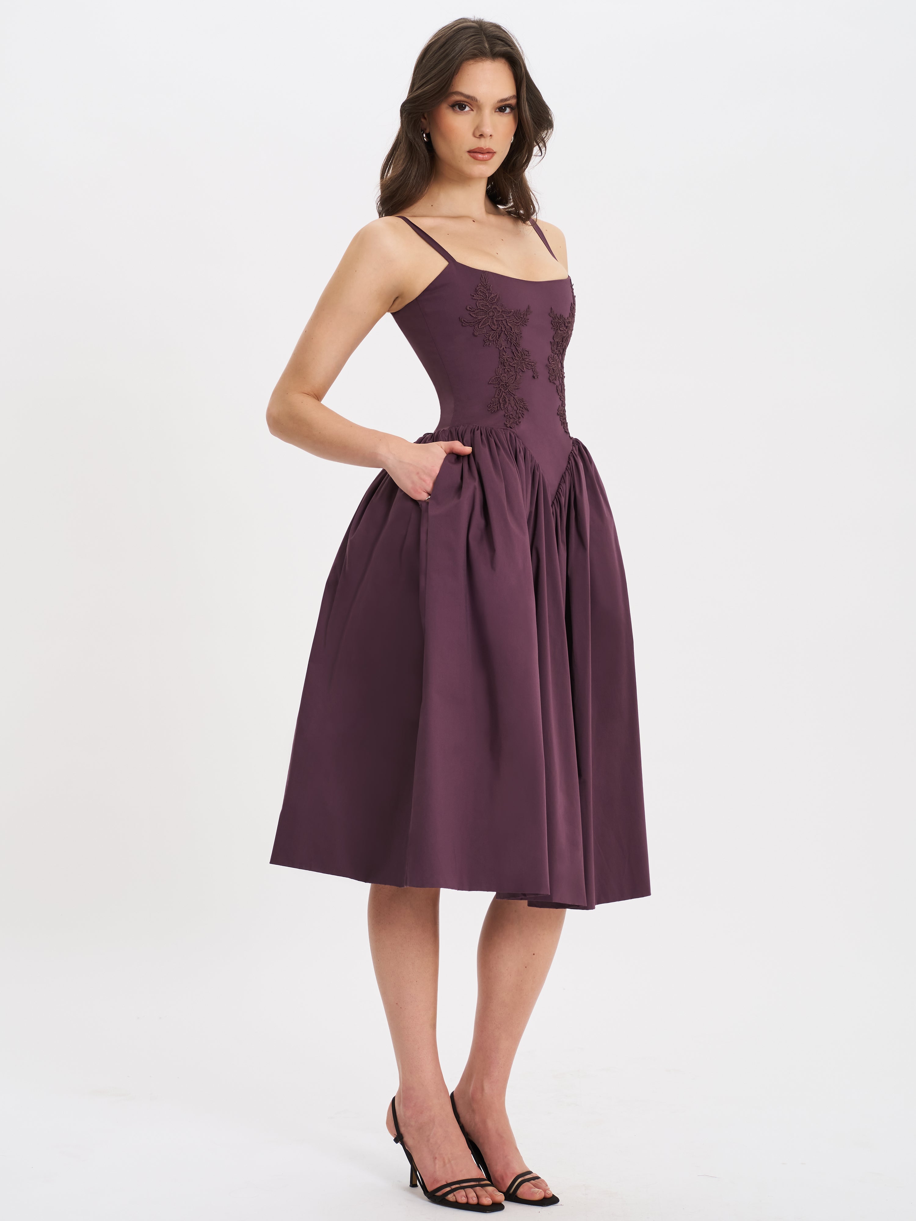 Purple embroidered midi dress for women, showing full skirt with hand in pocket detail.