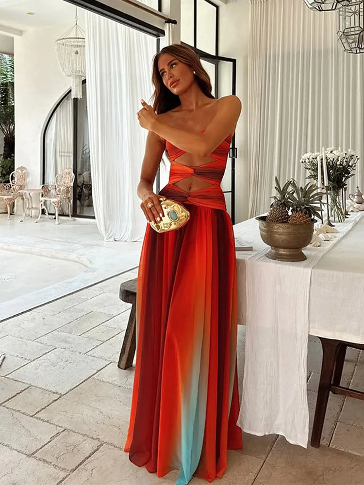 Elegant Callie Cutout Maxi Dress with a flowing skirt, displaying the vibrant color transition from orange to red to blue.