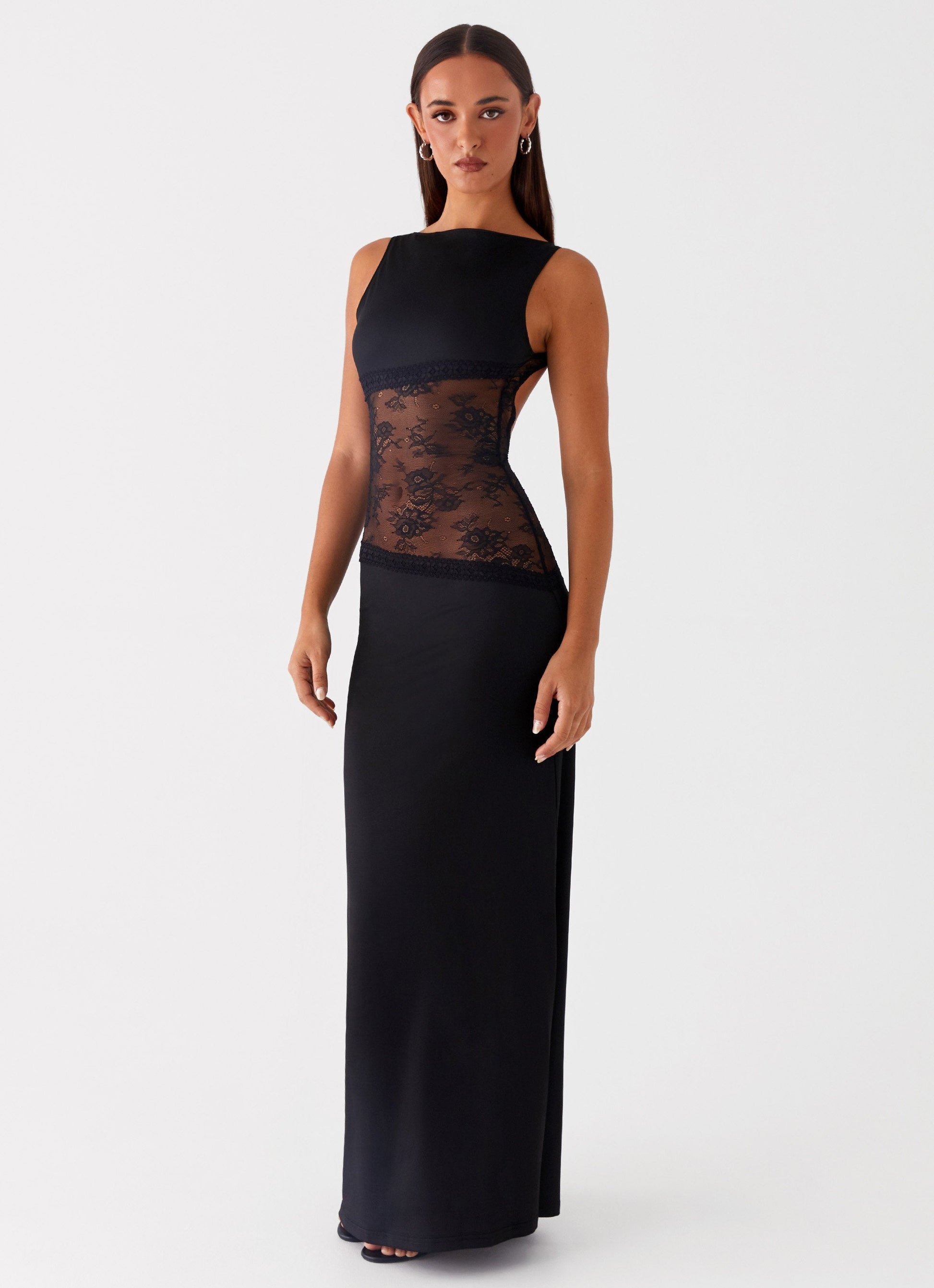 Side view of black Camille Lace Maxi Dress, showing sleeveless design and sheer lace paneling.