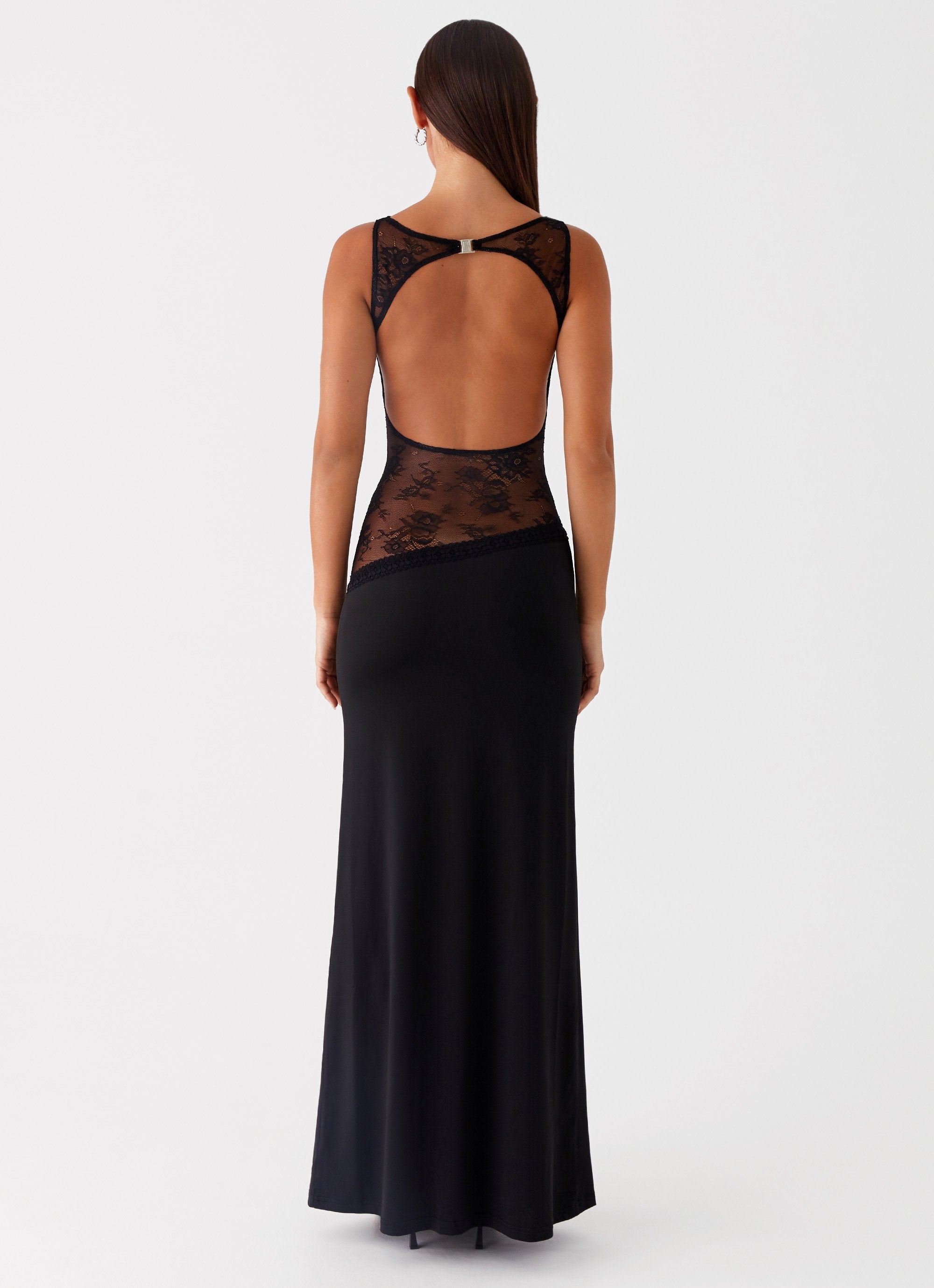 Back view of black Camille Lace Maxi Dress, featuring an open back with lace details and clasp.