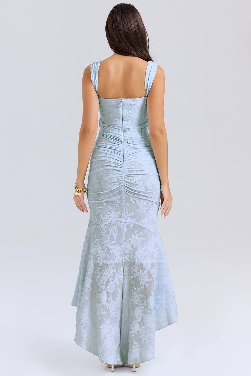 Back view of the light blue Carie corset maxi dress, highlighting the ruched detailing and asymmetric hemline.