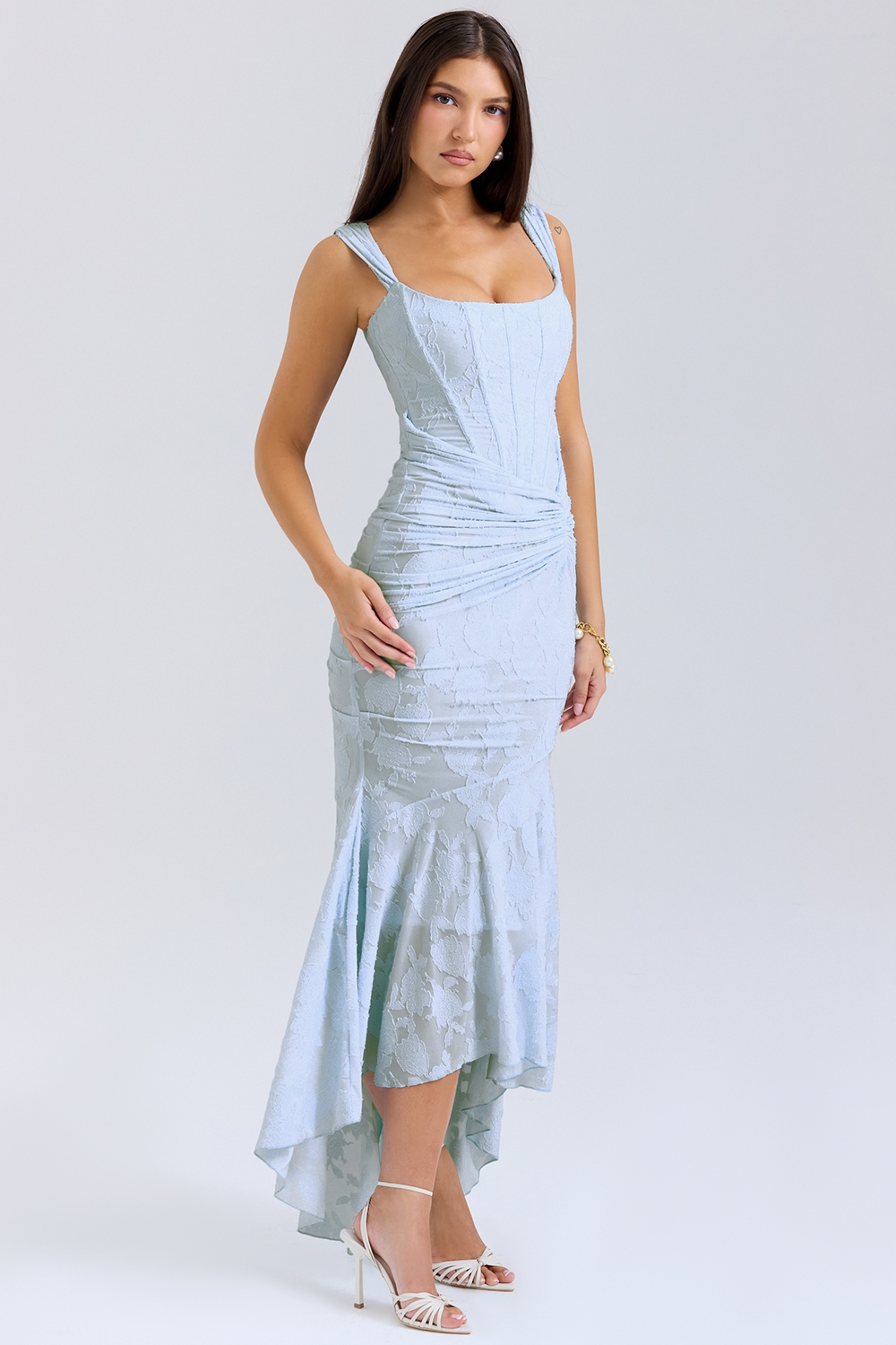 Three-quarter view of the light blue Carie corset maxi dress, showcasing the structured bodice and flowing skirt.