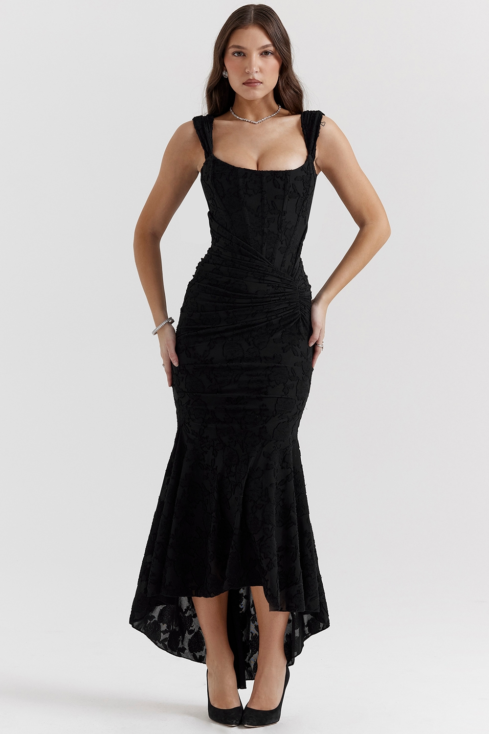 Black Carie corset maxi dress with a flattering ruched waist, floral jacquard fabric, and a stylish high-low hem.