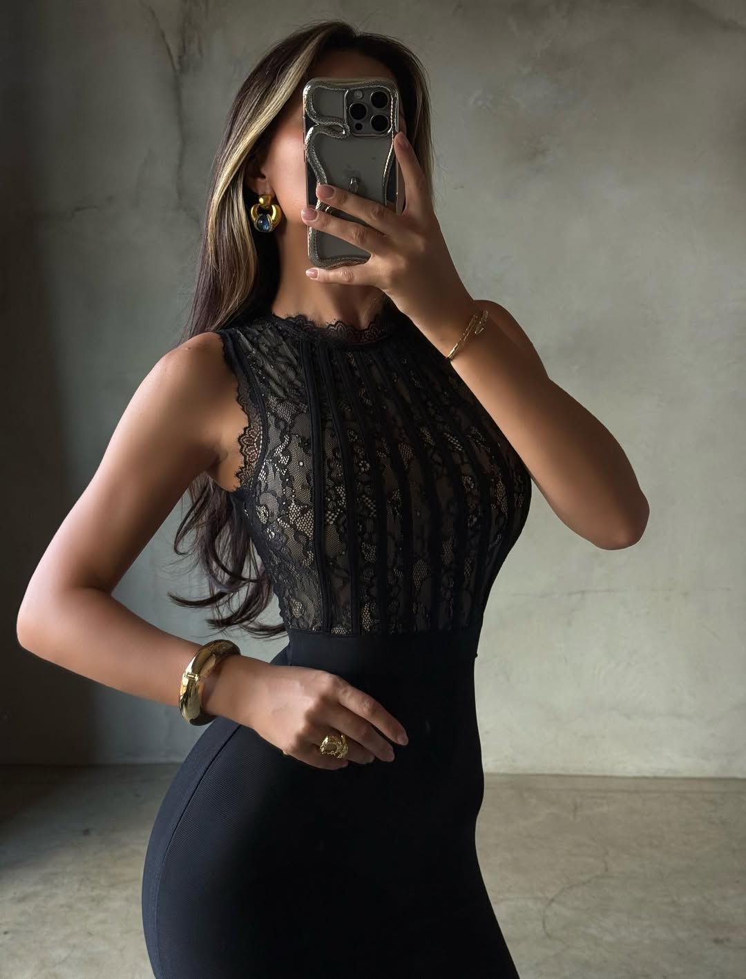 Close-up of the black Cecily Lace Midi Dress bodice, showing intricate lace patterns and vertical pleats.