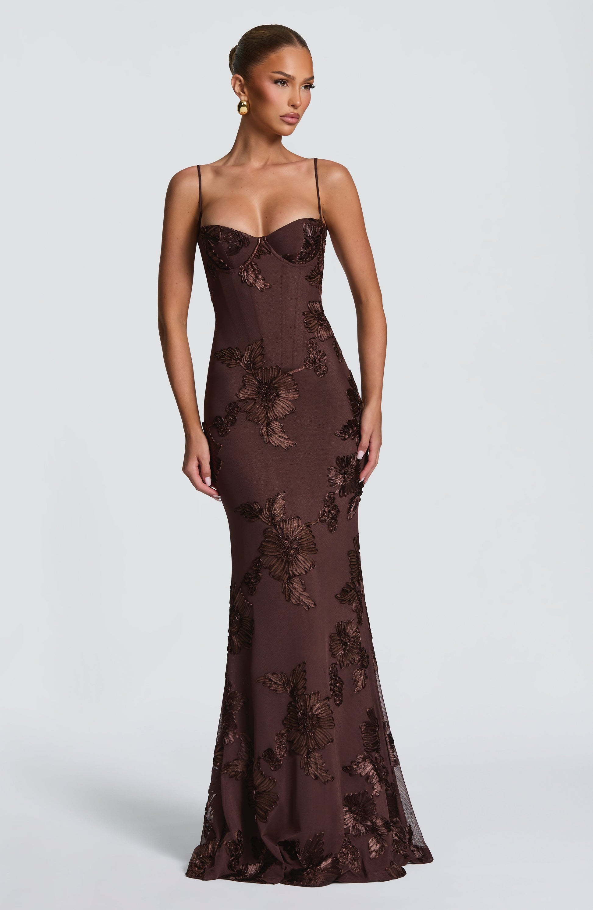 Front view of a brown floral maxi dress with a structured bodice and elegant floral appliqués, perfect for plus size cocktail wear.