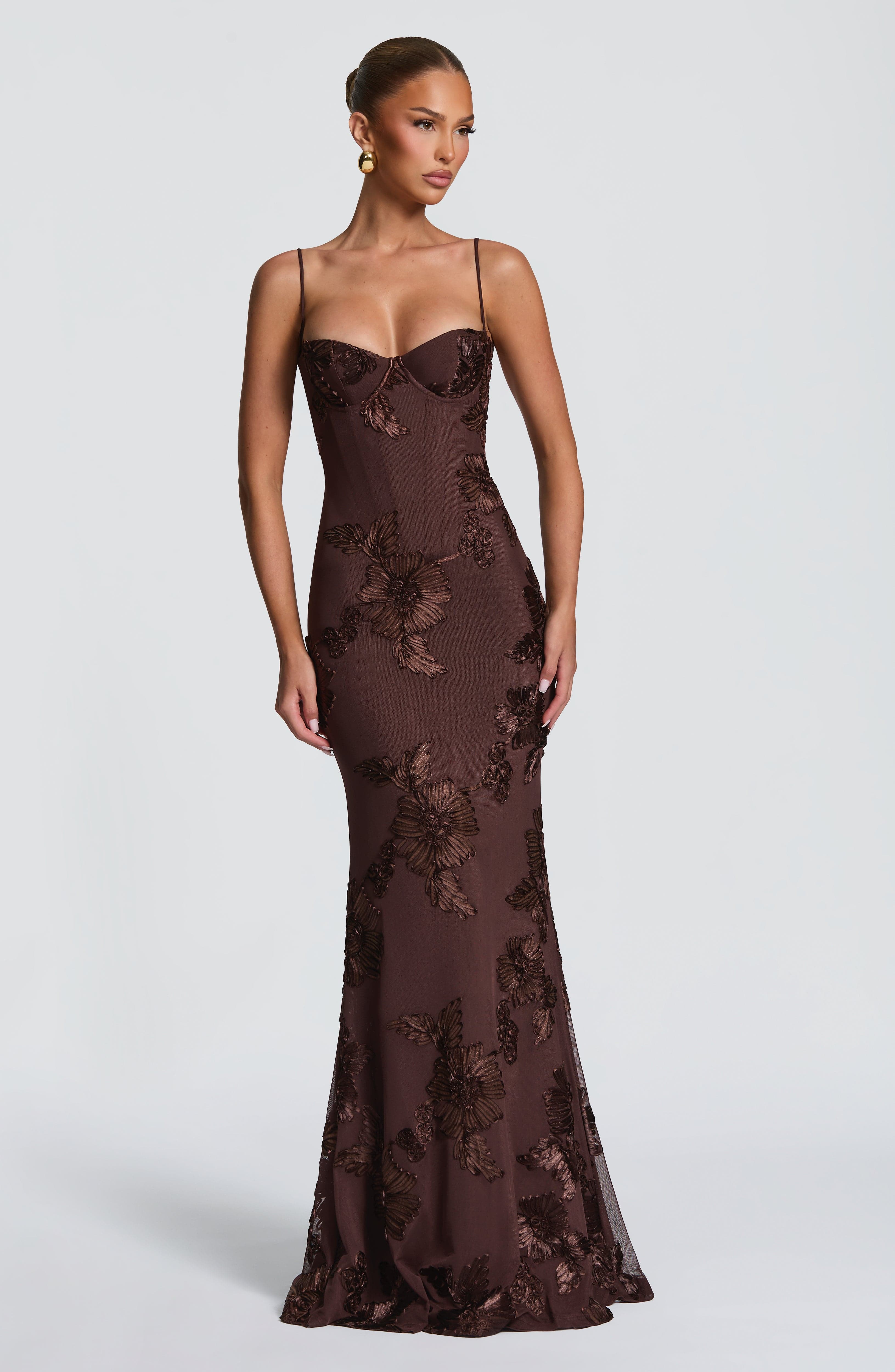 Front view of a brown floral maxi dress with a structured bodice and elegant floral appliqués, perfect for plus size cocktail wear.