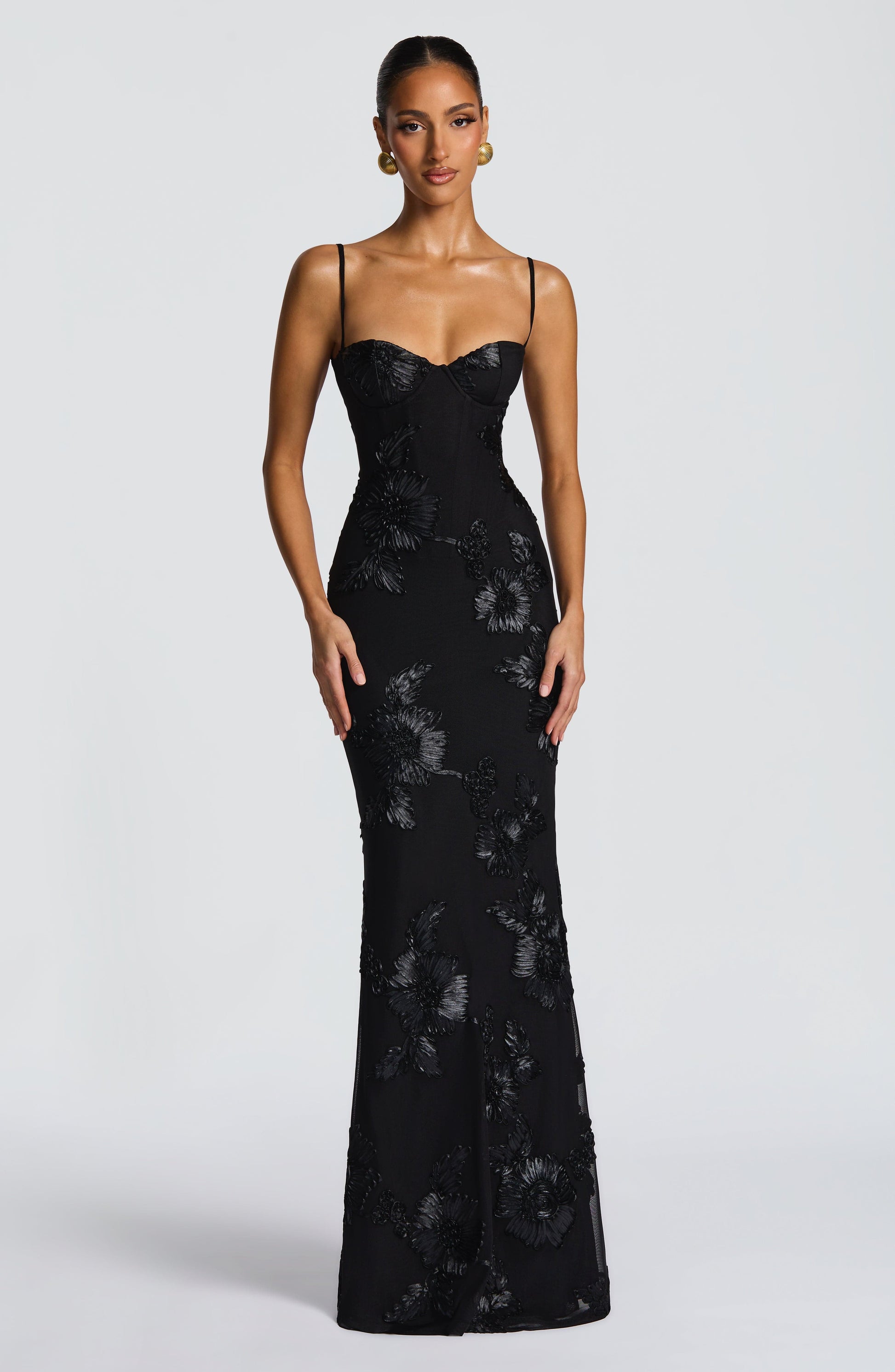 Full view of the black Celestina Floral Maxi Dress, showcasing the form-fitting silhouette and detailed floral embellishments.