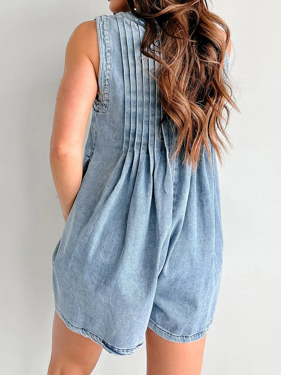 Back view of the light blue denim mini dress, showcasing the pleated detailing on the upper back.