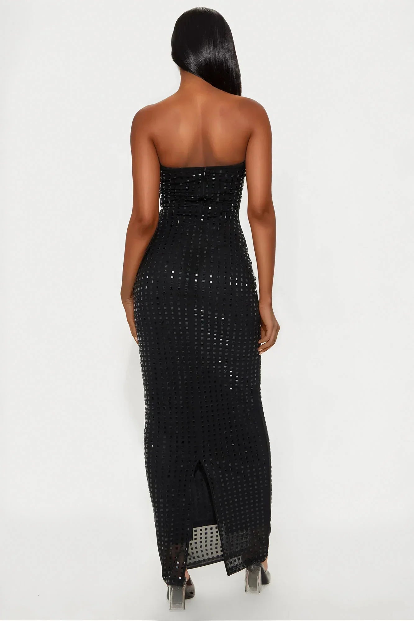Back view of a black sequin strapless maxi dress for women, showing zipper closure and slit.