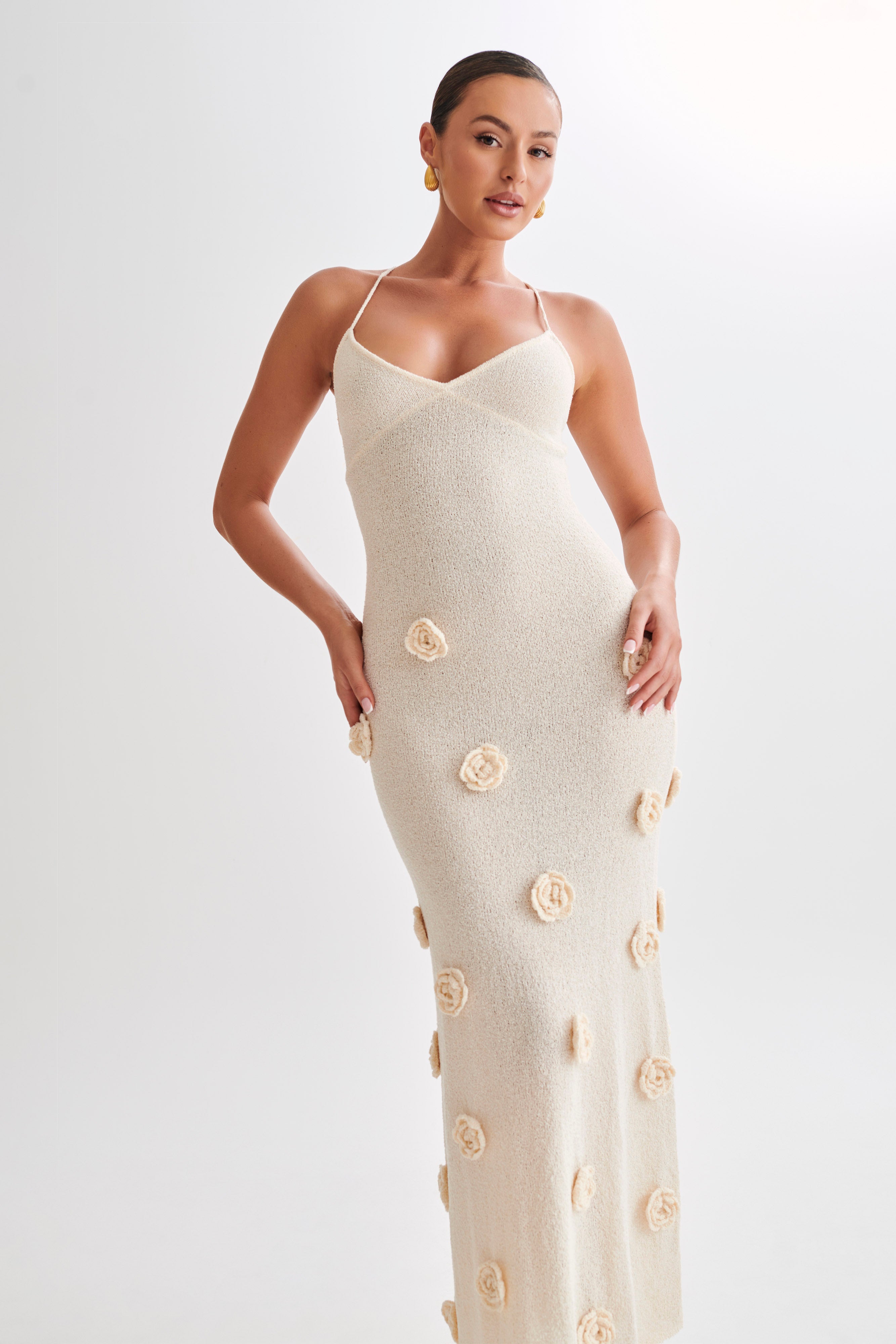 Side profile of the cream Chelsea Floral Maxi Dress, showing the V-neckline and scattered floral embellishments on the skirt.