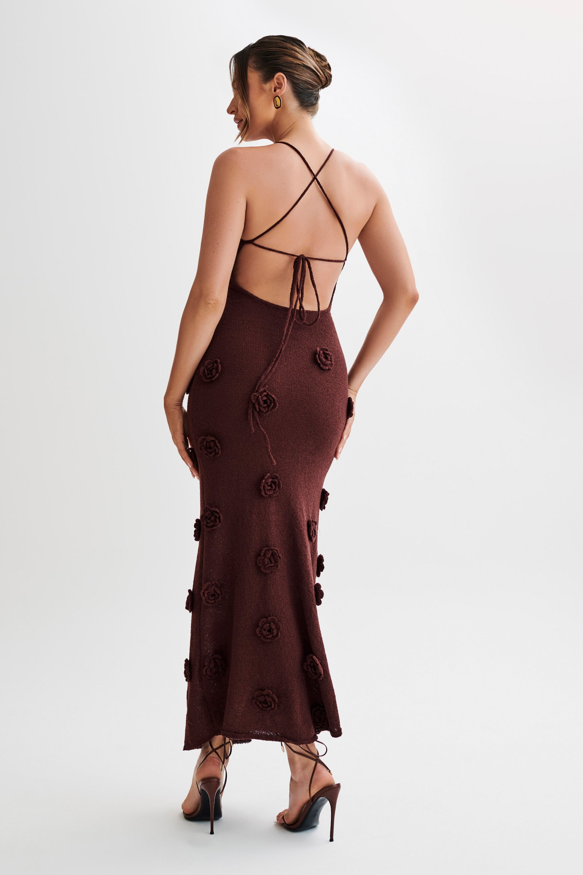 Rear view of the dark brown Chelsea Floral Maxi Dress, displaying the low back, criss-cross ties, and textured floral details.
