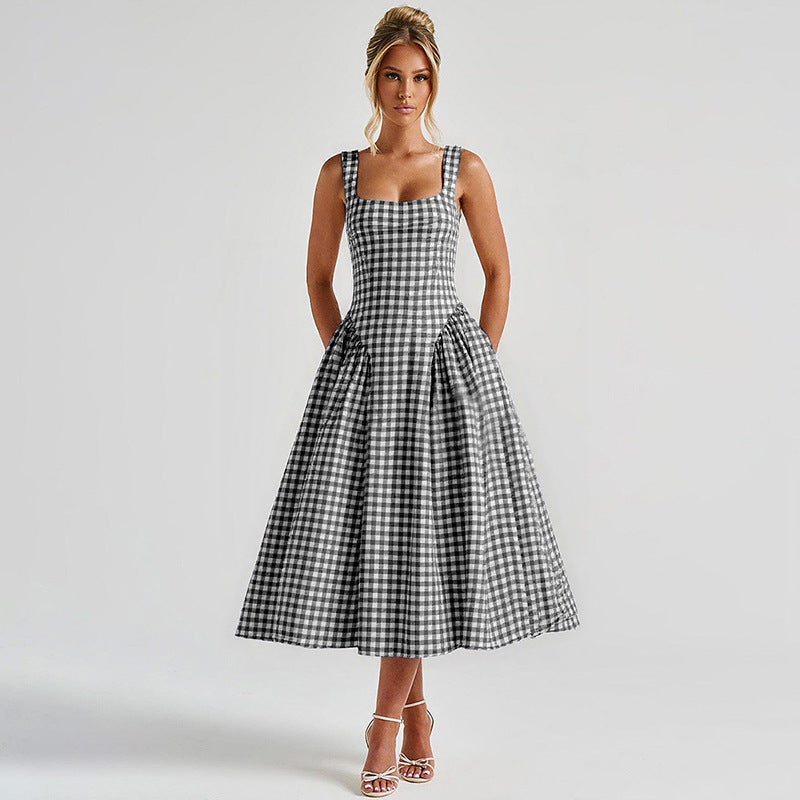 Full shot of a black and white gingham midi dress, designed with a square neckline and a full skirt, offering a sophisticated look.