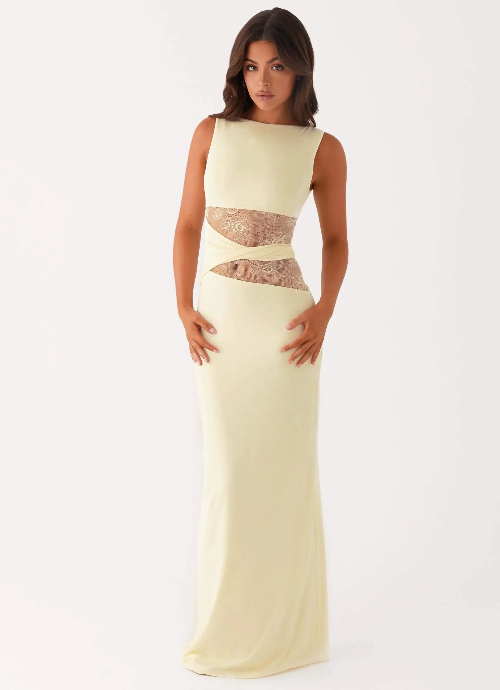 Sleeveless pale yellow Clarisse maxi dress with sheer lace cutouts at the waist, front view