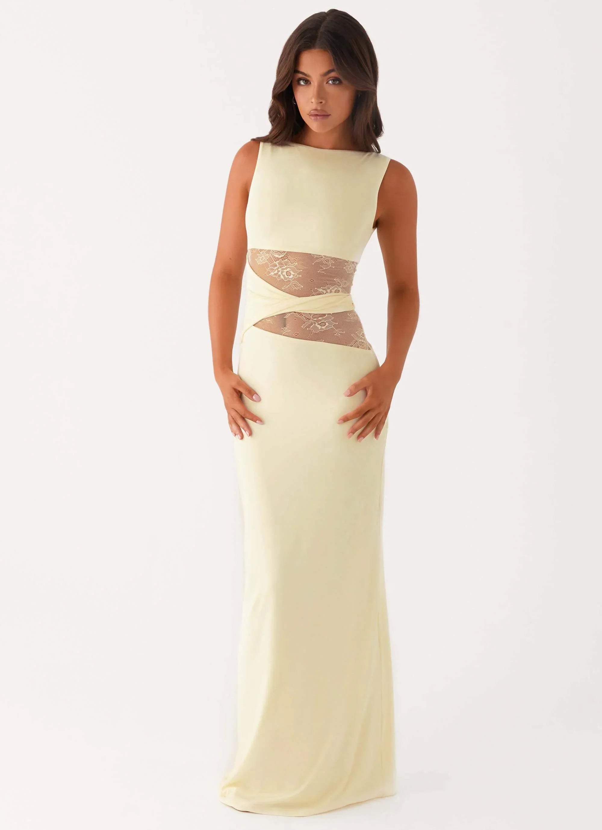 Sleeveless pale yellow Clarisse maxi dress with sheer lace cutouts at the waist, front view