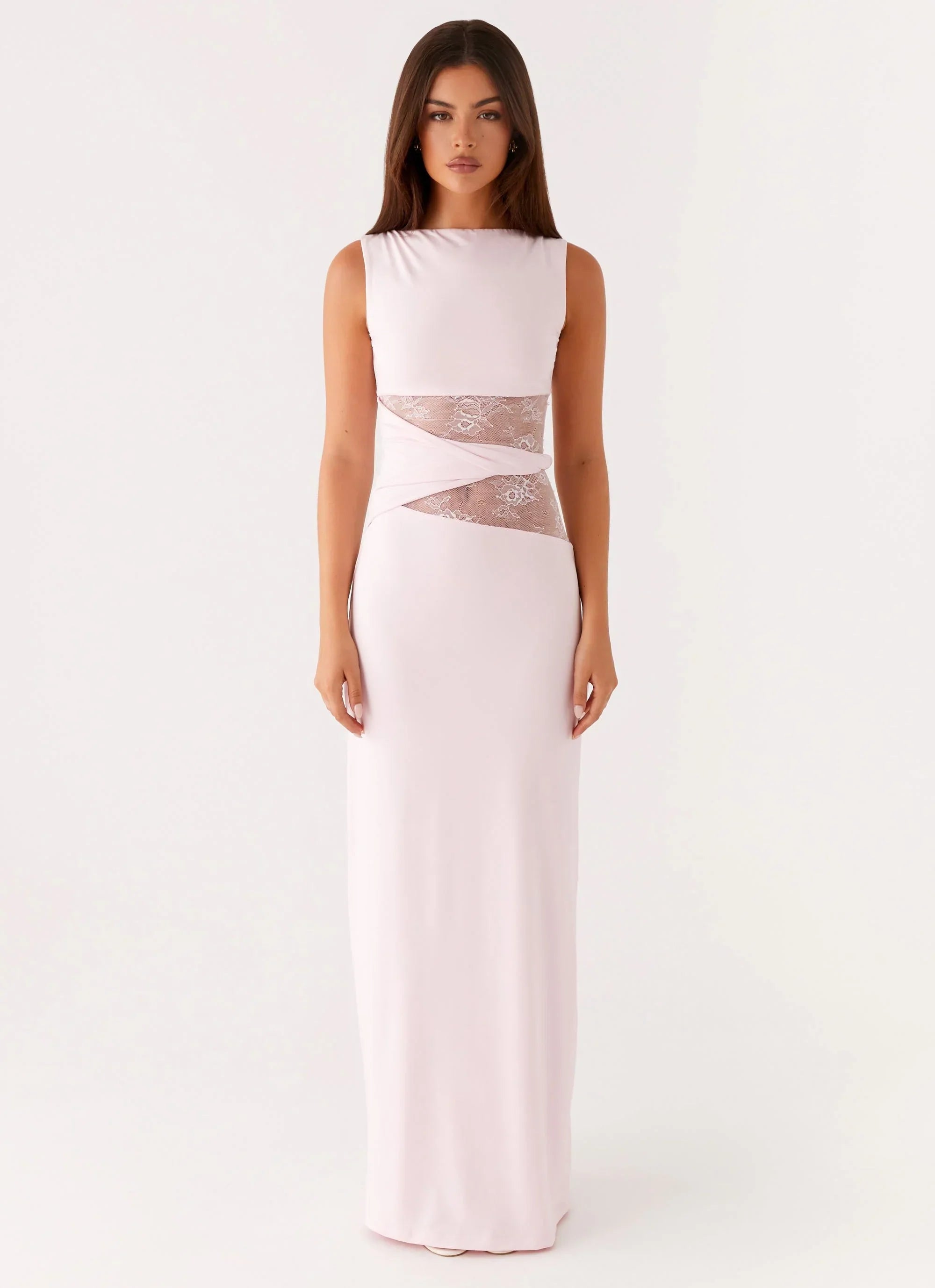 Blush pink Clarisse maxi dress with a sleeveless silhouette and delicate lace inserts creating a cinched waist effect.