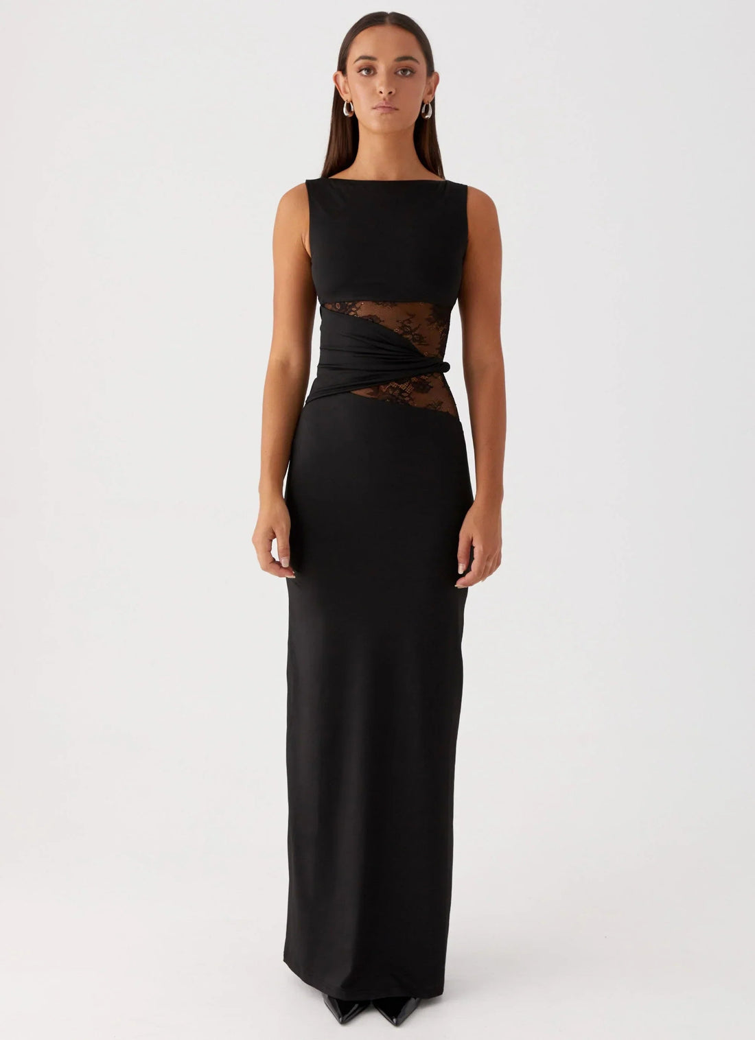 Sleeveless black Clarisse maxi dress with boat neck and sheer lace cutouts at the waist, front view.