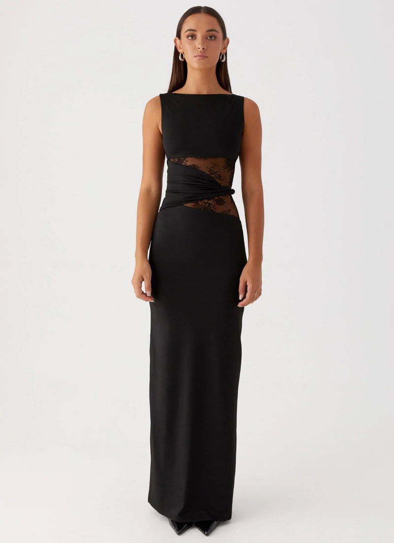 Sleeveless black Clarisse maxi dress with boat neck and sheer lace cutouts at the waist, front view.