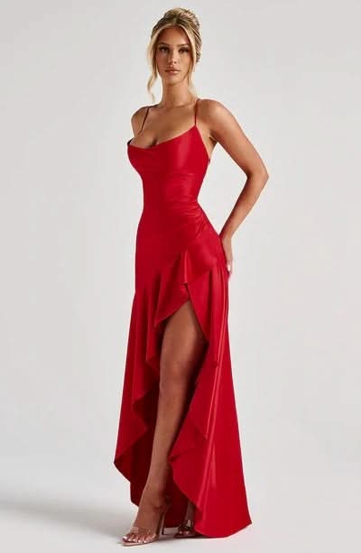 Full length front view of red Daisy Ruffle Maxi Dress, highlighting the thigh-high slit and draped skirt.