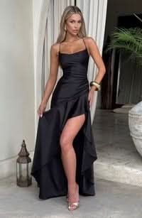 Front view of a black maxi dress with a ruffled high-low skirt, thin straps, and a form-fitting silhouette.