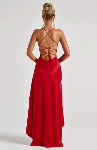 Back view of red Daisy Ruffle Maxi Dress, featuring a criss-cross lace-up back detail and flowing skirt.