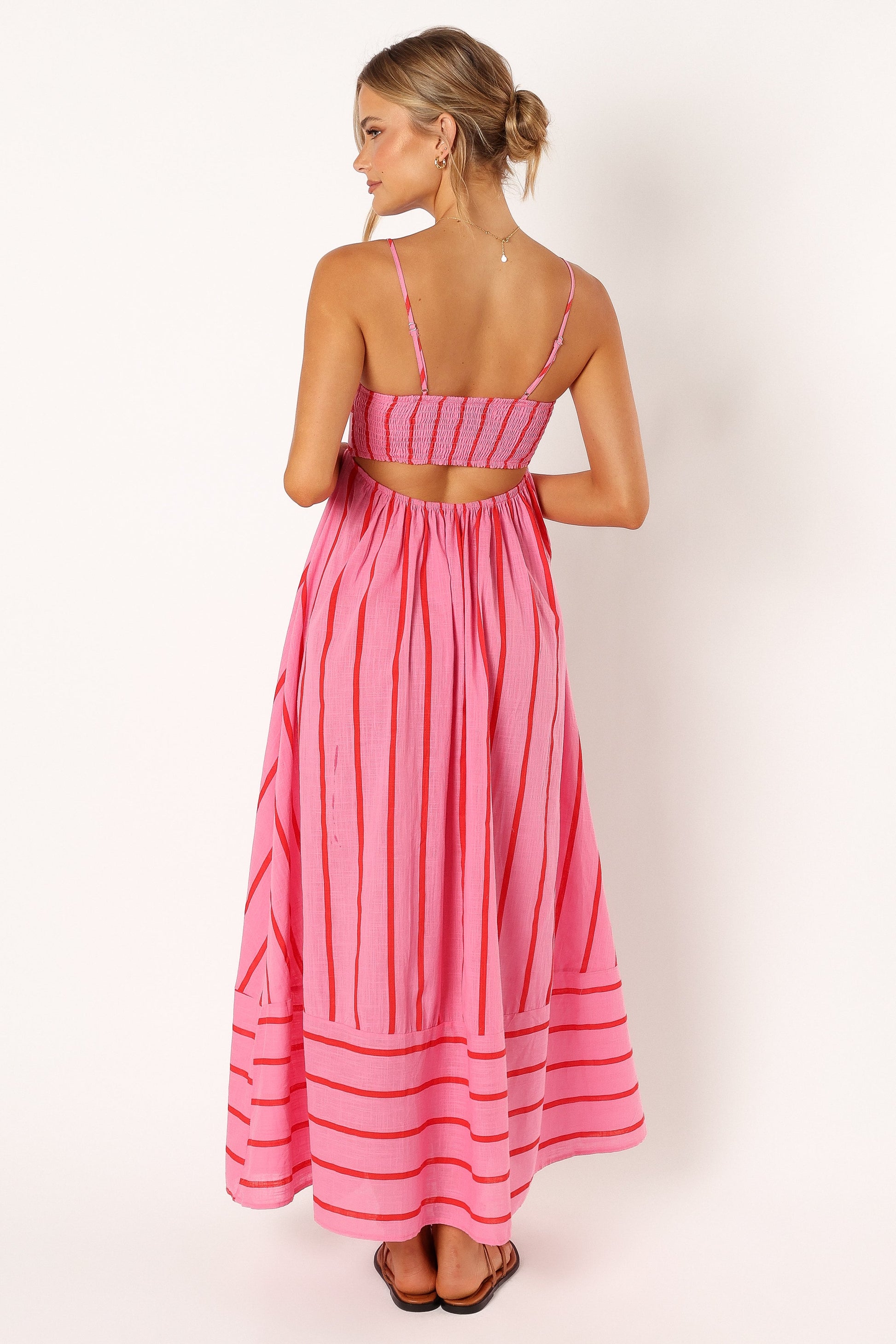Yellow striped maxi dress in motion — beach-inspired outfit paired with accessories