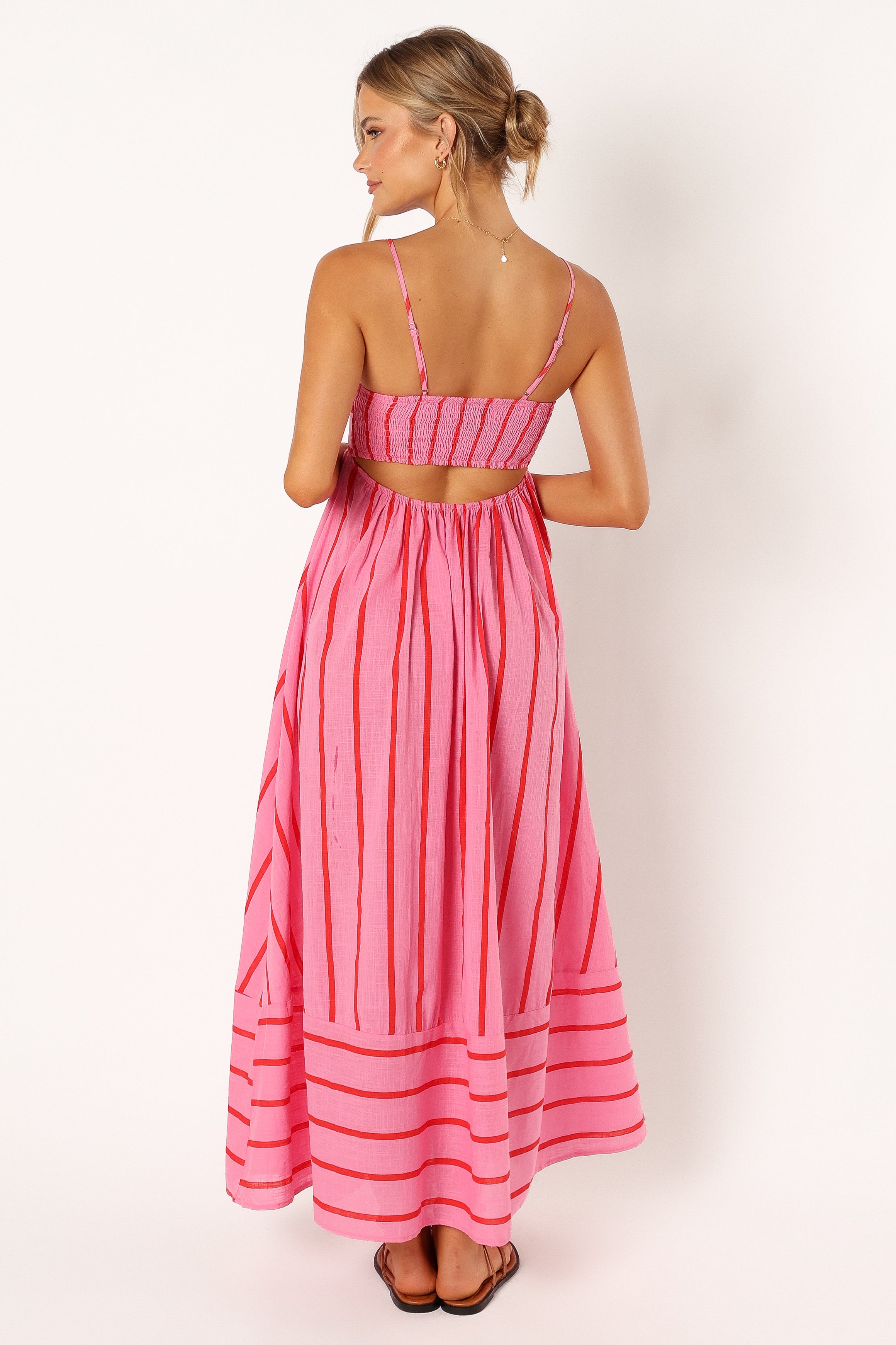 Yellow striped maxi dress in motion — beach-inspired outfit paired with accessories