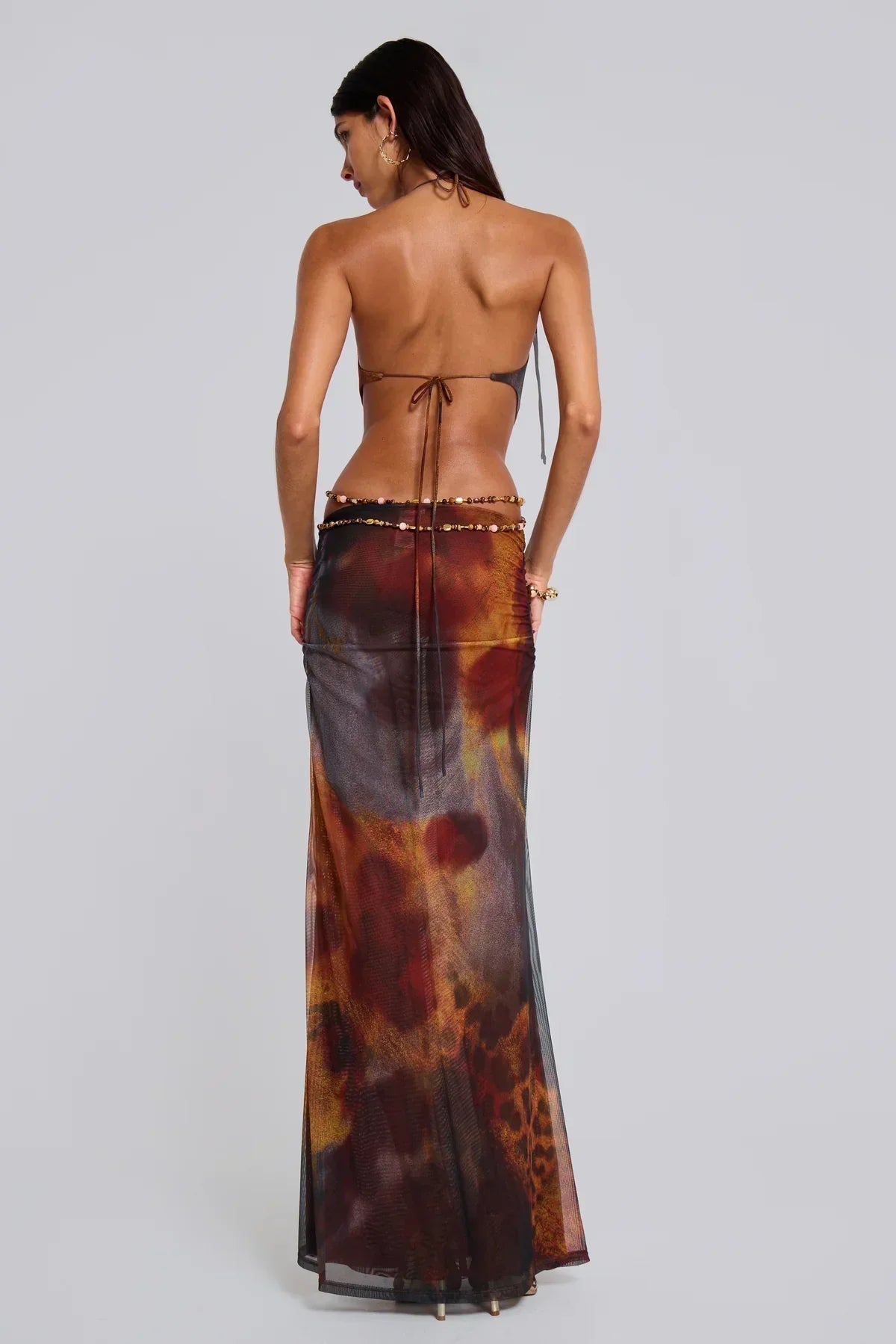Back view of women's brown and red cutout backless maxi dress with delicate tie details