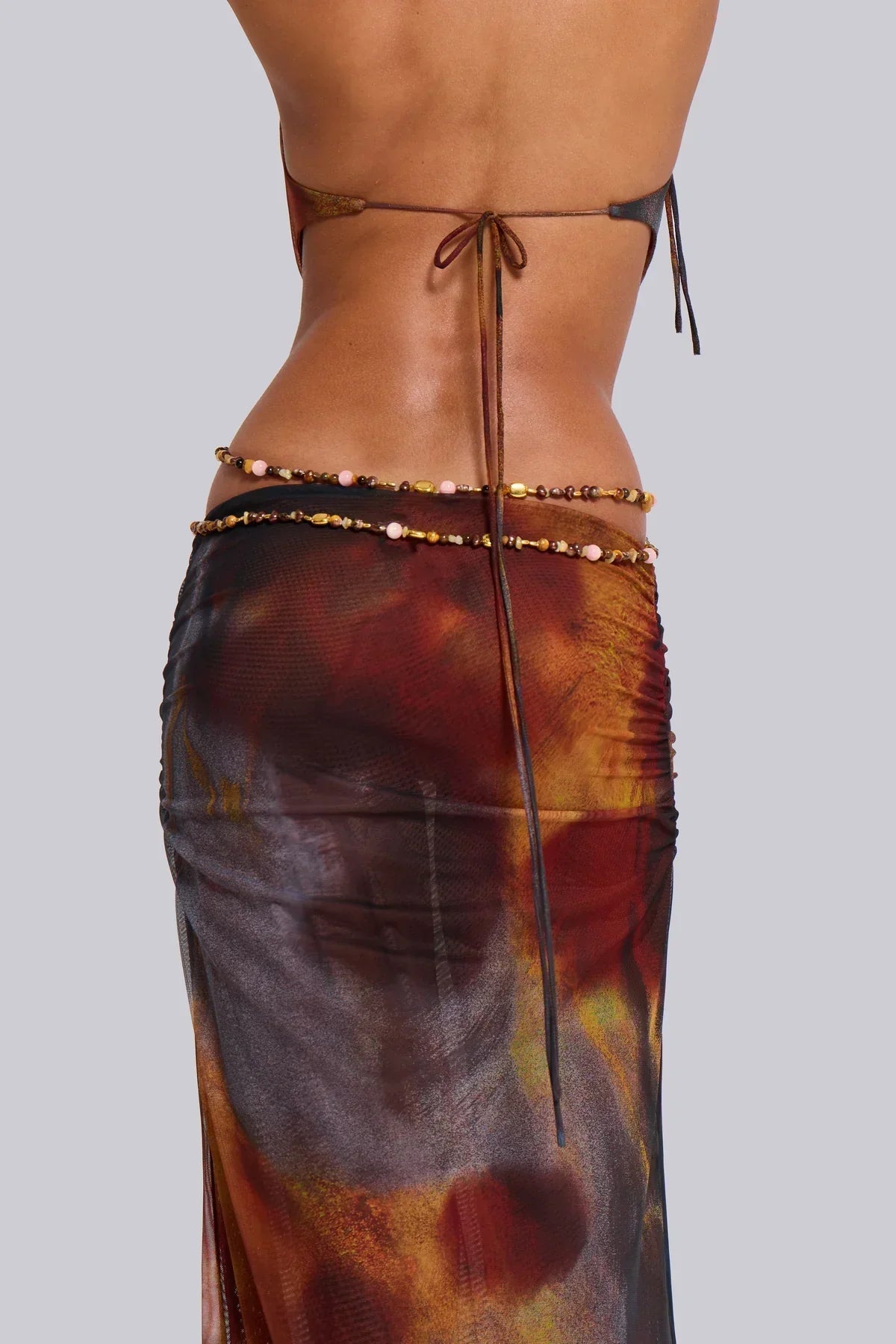 Detail of the back of the brown print maxi dress showing waist chain and tie closure for women