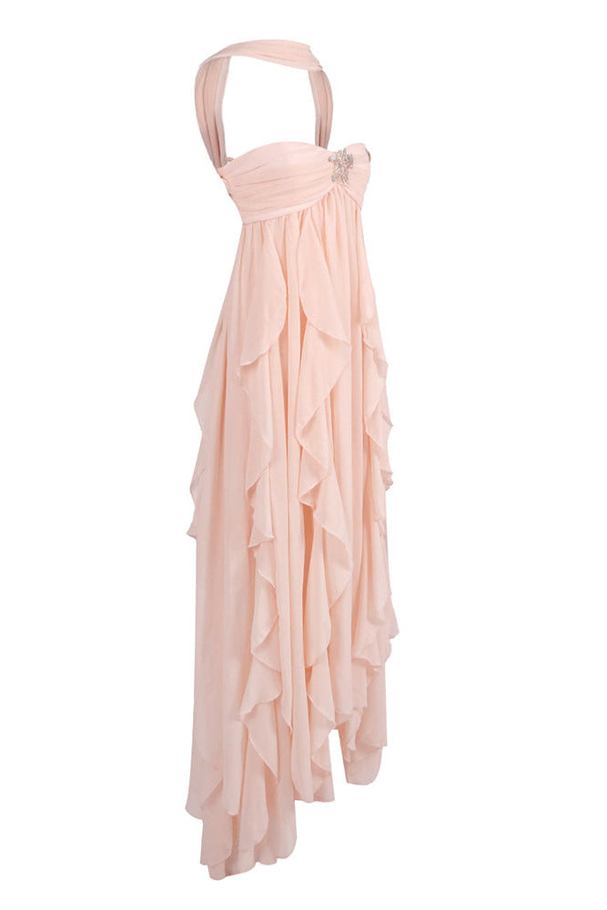 Side view of Elaina peach ruched maxi dress, showing flowing tiered ruffles and halter straps
