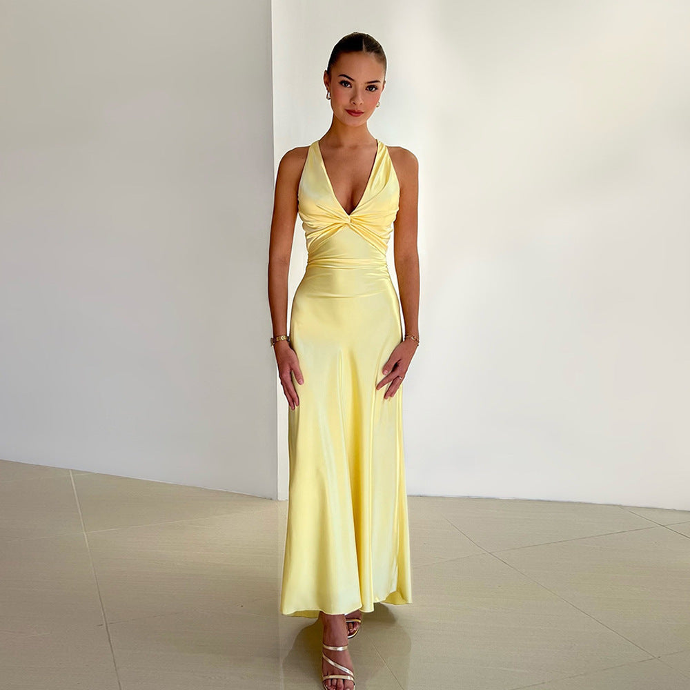 Full-length yellow satin maxi dress with a twisted knot bodice and V-neckline, perfect for a wedding.