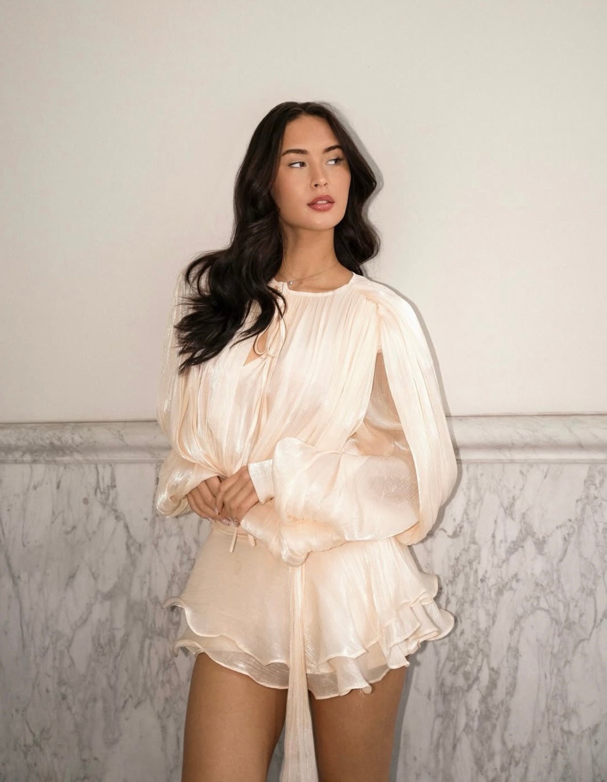 Light peach Elianna shirred mini dress with long voluminous sleeves and a tie-neck detail, shown from the front.