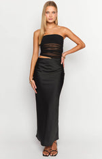 Full-length view of a strapless black maxi dress with a sheer ruched bodice and side cutout detail.