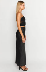 Side profile of the black Elinor cutout maxi dress, showing the strapless bodice and subtle side cutout.
