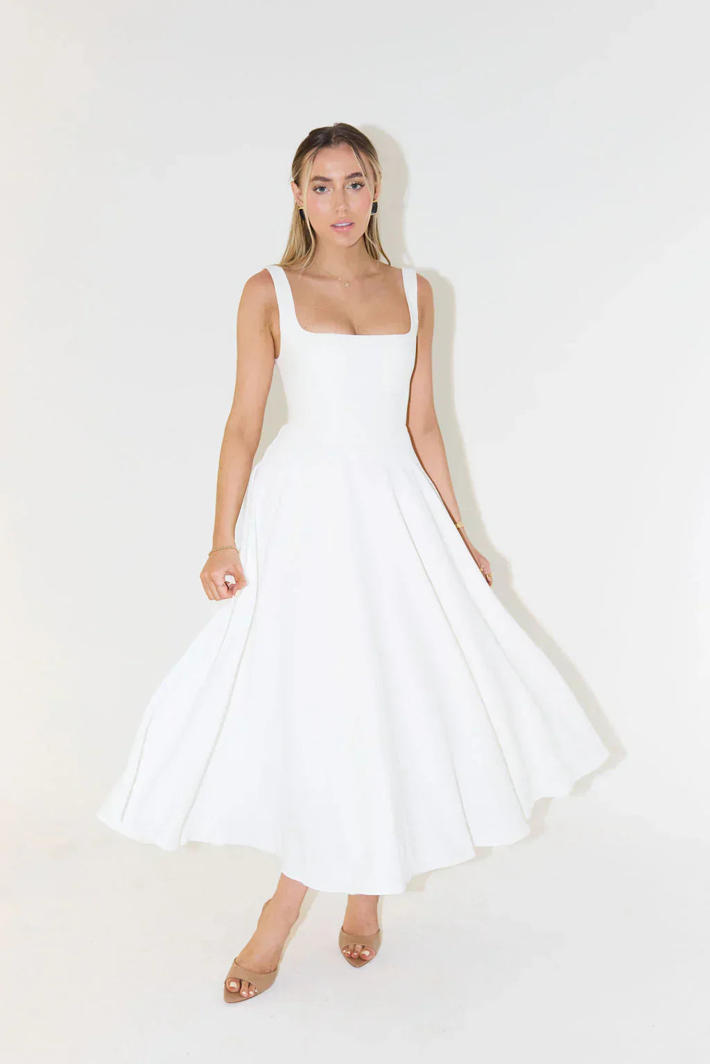 Full length view of the Eliza A-line midi dress in white, showcasing the elegant silhouette and square neckline.