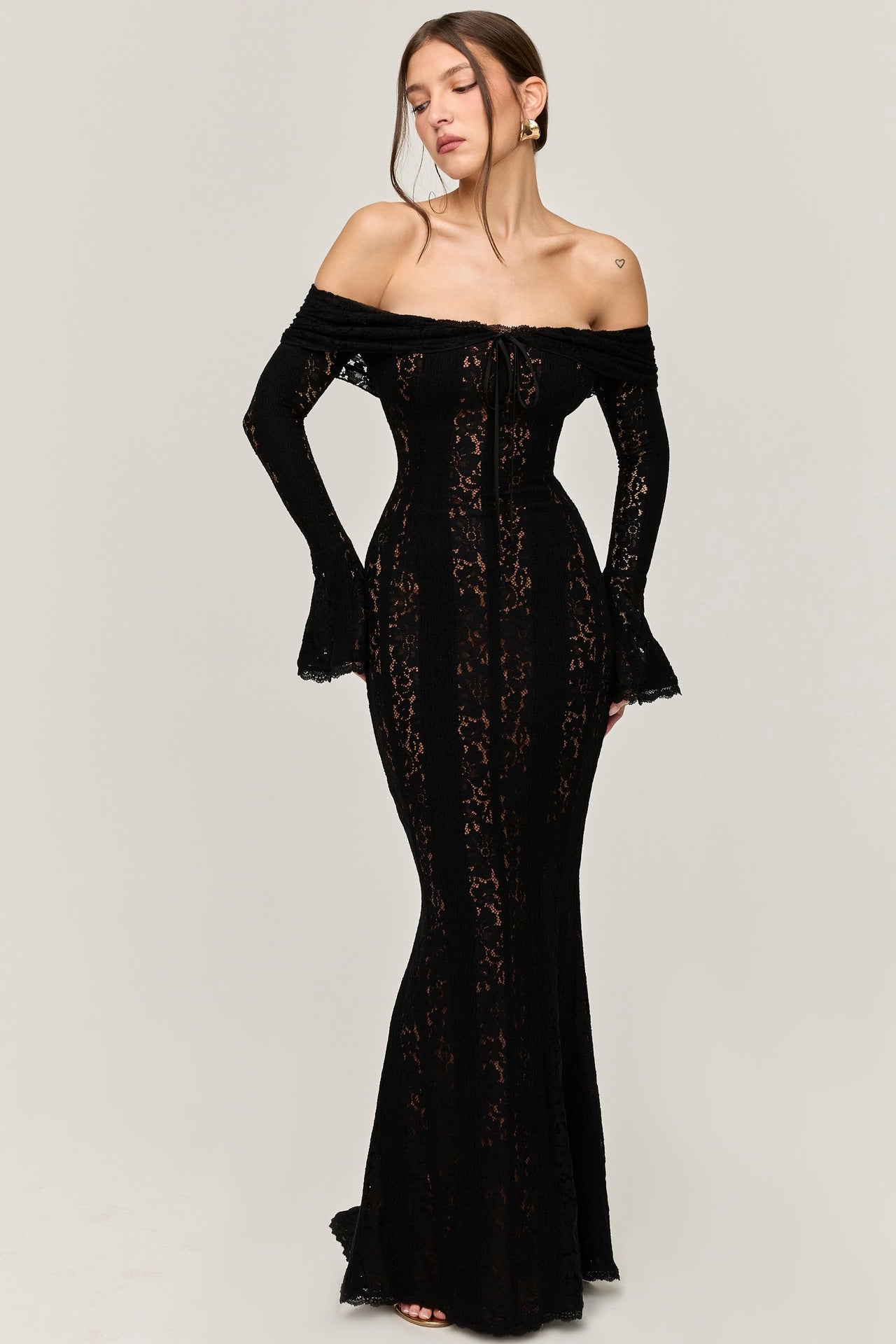Full-length black lace maxi dress with off-the-shoulder design, long bell sleeves, and a fitted bodice with a tie-front detail.