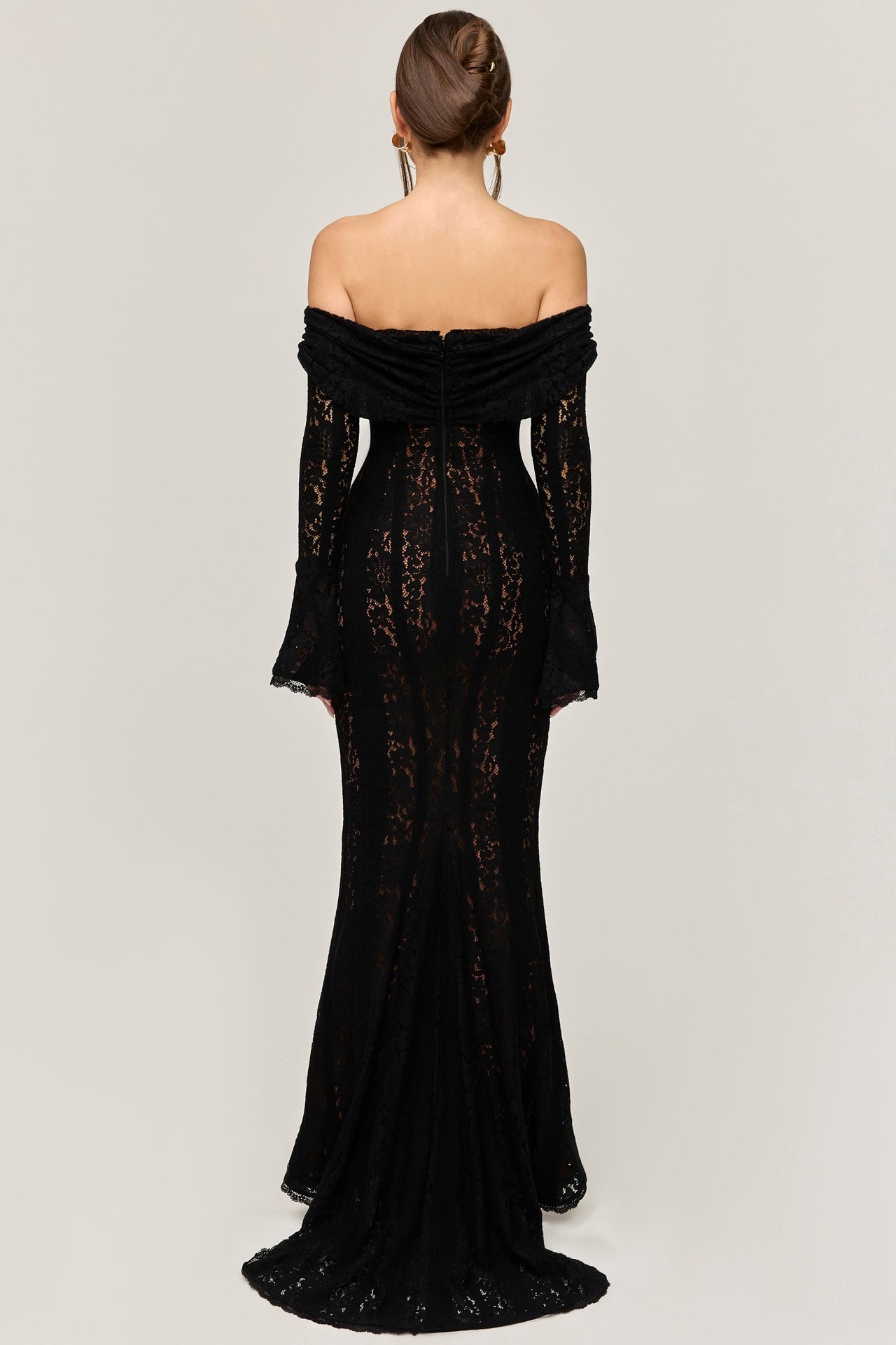 Rear view of the black lace maxi dress, displaying the off-the-shoulder back and the elegant flow of the maxi skirt.