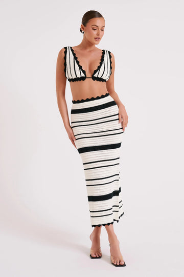 Front view of a white and black striped crochet maxi set with a scalloped bralette and skirt.