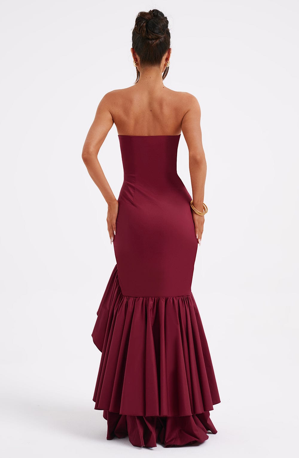 Back view of the strapless burgundy Emily Ruffle Maxi Dress, showing the elegant train and layered ruffles.