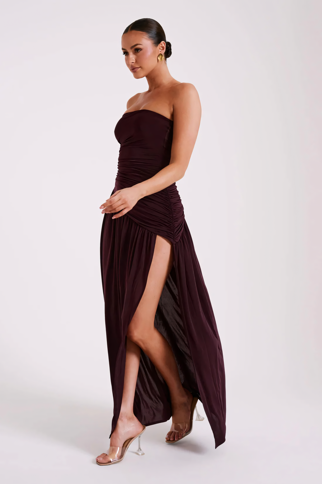 Burgundy strapless ruched maxi dress with a high side slit for women, front view