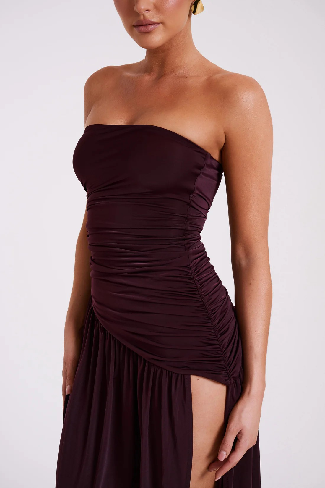 Close-up of the ruched bodice and high side slit detail on the burgundy maxi dress for women