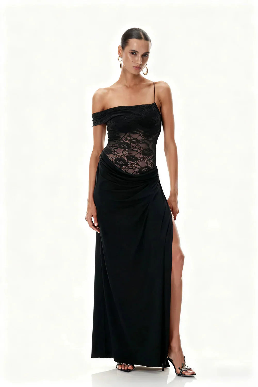 Full-length studio shot of the Emmalyn Lace Maxi Dress in classic black, with a lace off-shoulder design and high slit.