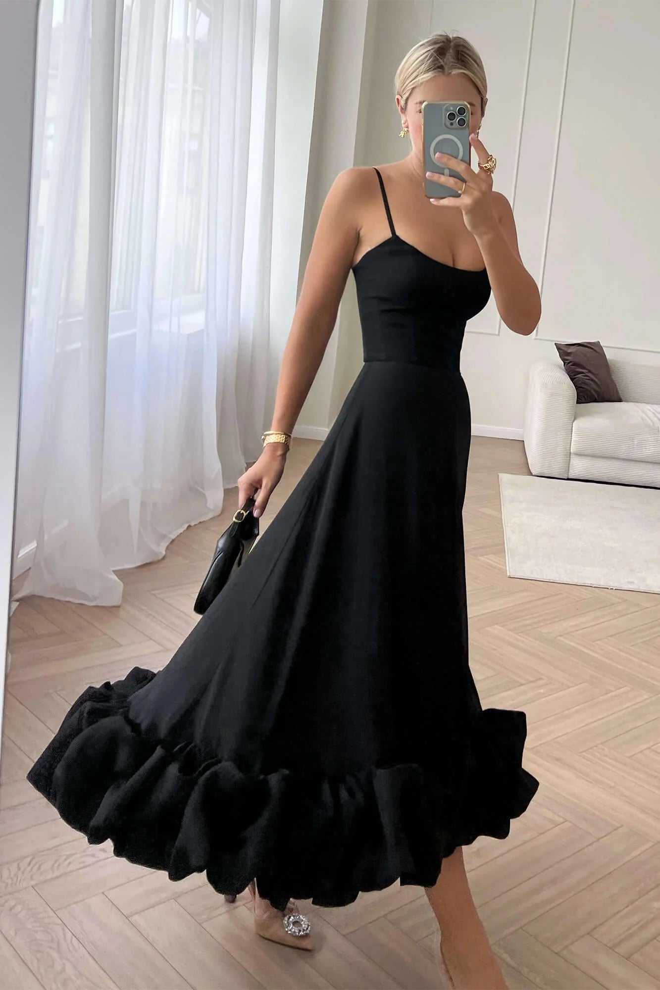 Black Emmeline ruffle midi dress with a flattering silhouette, thin straps, and a voluminous tiered ruffled hem.