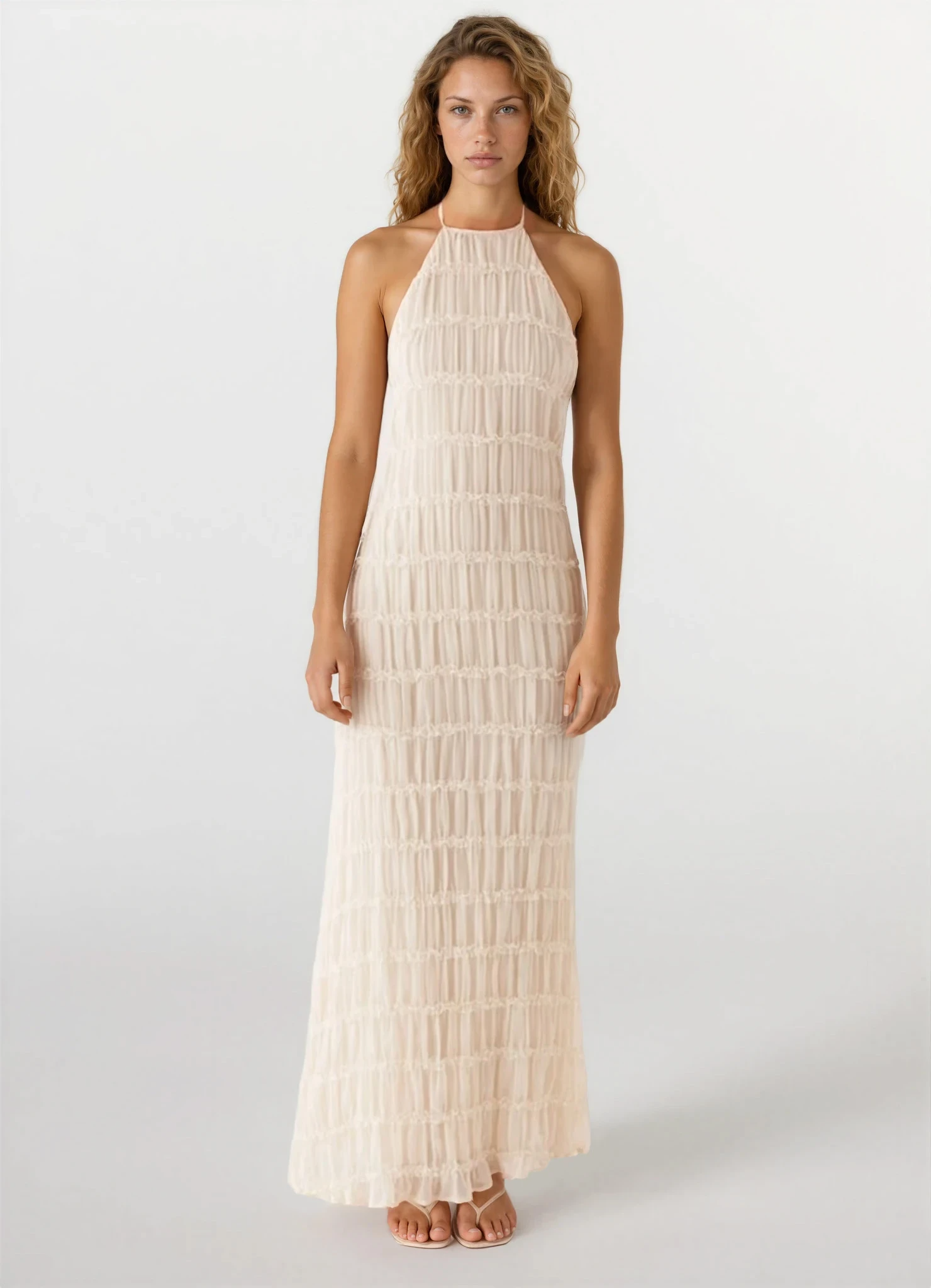 Full-length front view of a light cream Everly textured maxi dress with a halter neck and intricate ruched detailing on a white background.