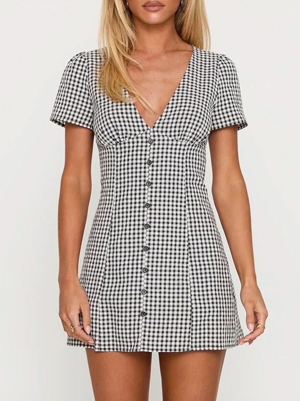 Front view of the Fallon Check Mini Dress in a black and white gingham pattern, with short sleeves, a v-neck, and a full button-down front.