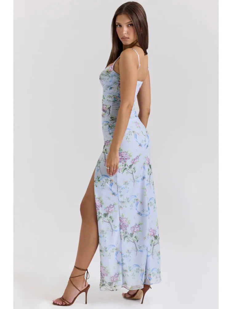 Profile view of a light blue floral maxi dress with a flowing skirt and elegant side slit, paired with brown heels.
