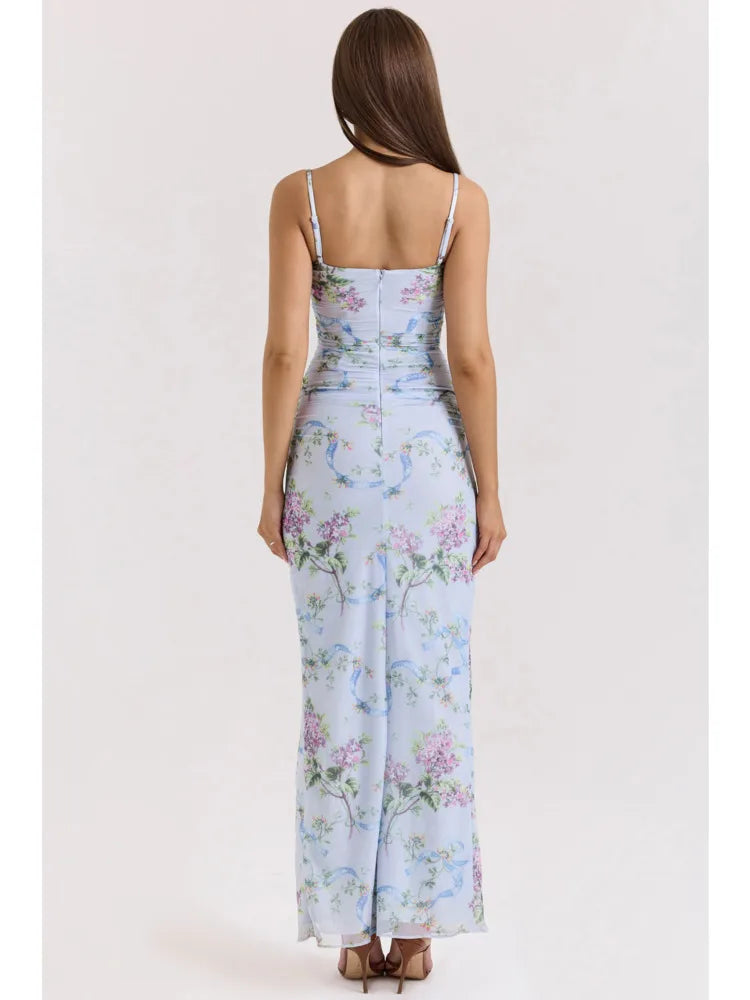 Back view of a light blue floral maxi dress with ruched details on the back and a subtle floral print.