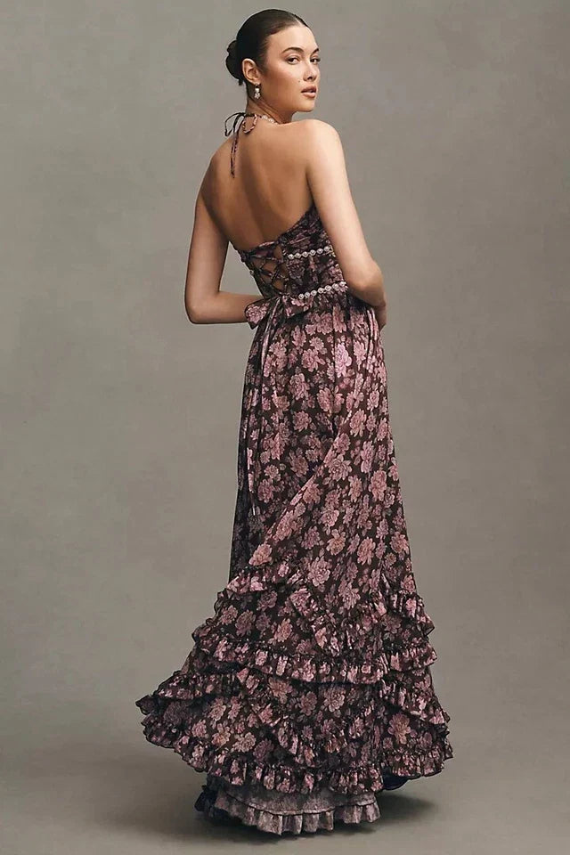 Back view of brown floral tiered maxi dress with pearl trim, lace-up back, and ruffled skirt.