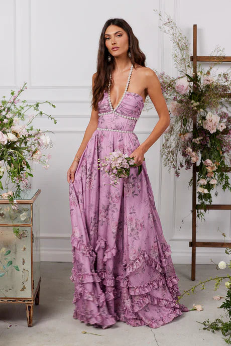 Lavender floral tiered maxi dress with pearl trim, deep V-neck, and ruffled skirt details.