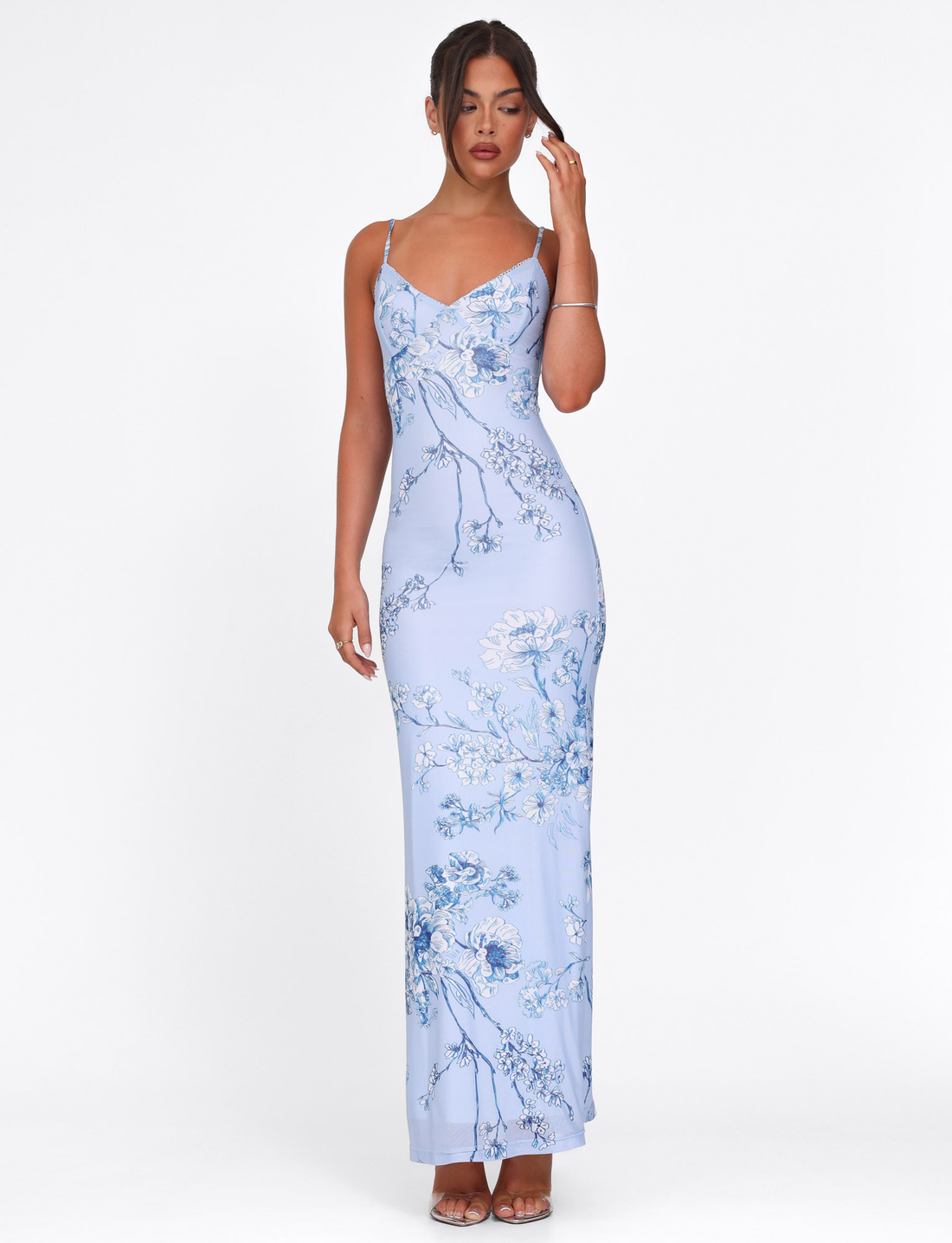 Light blue floral maxi dress with delicate spaghetti straps and v-neckline, featuring white and navy floral patterns.