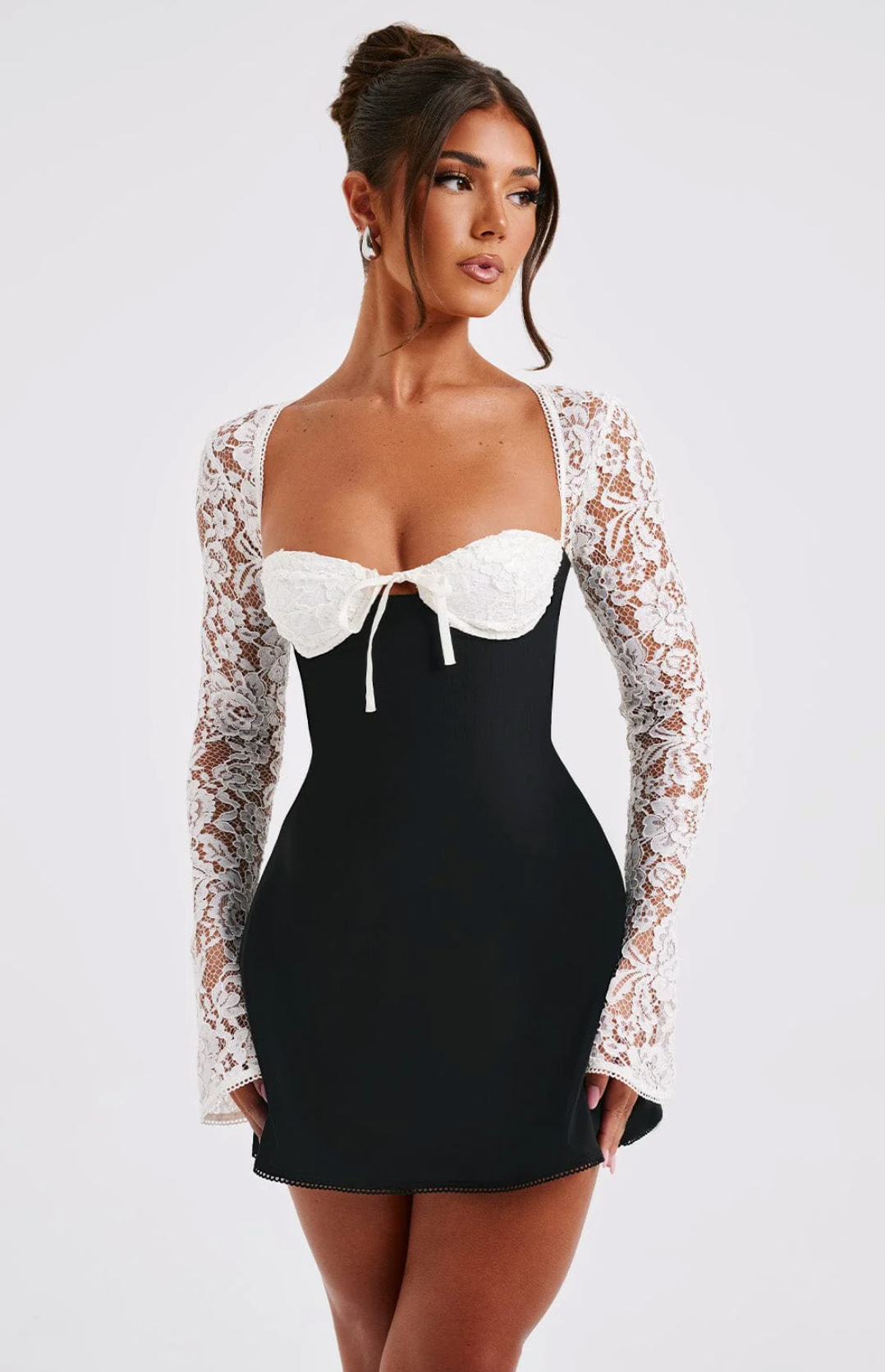 Black Gemma Tie Mini Dress with white lace sleeves and a white tie-front bust detail.